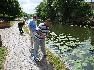 Fishermen clearing canal weed, Brades Village.jpg